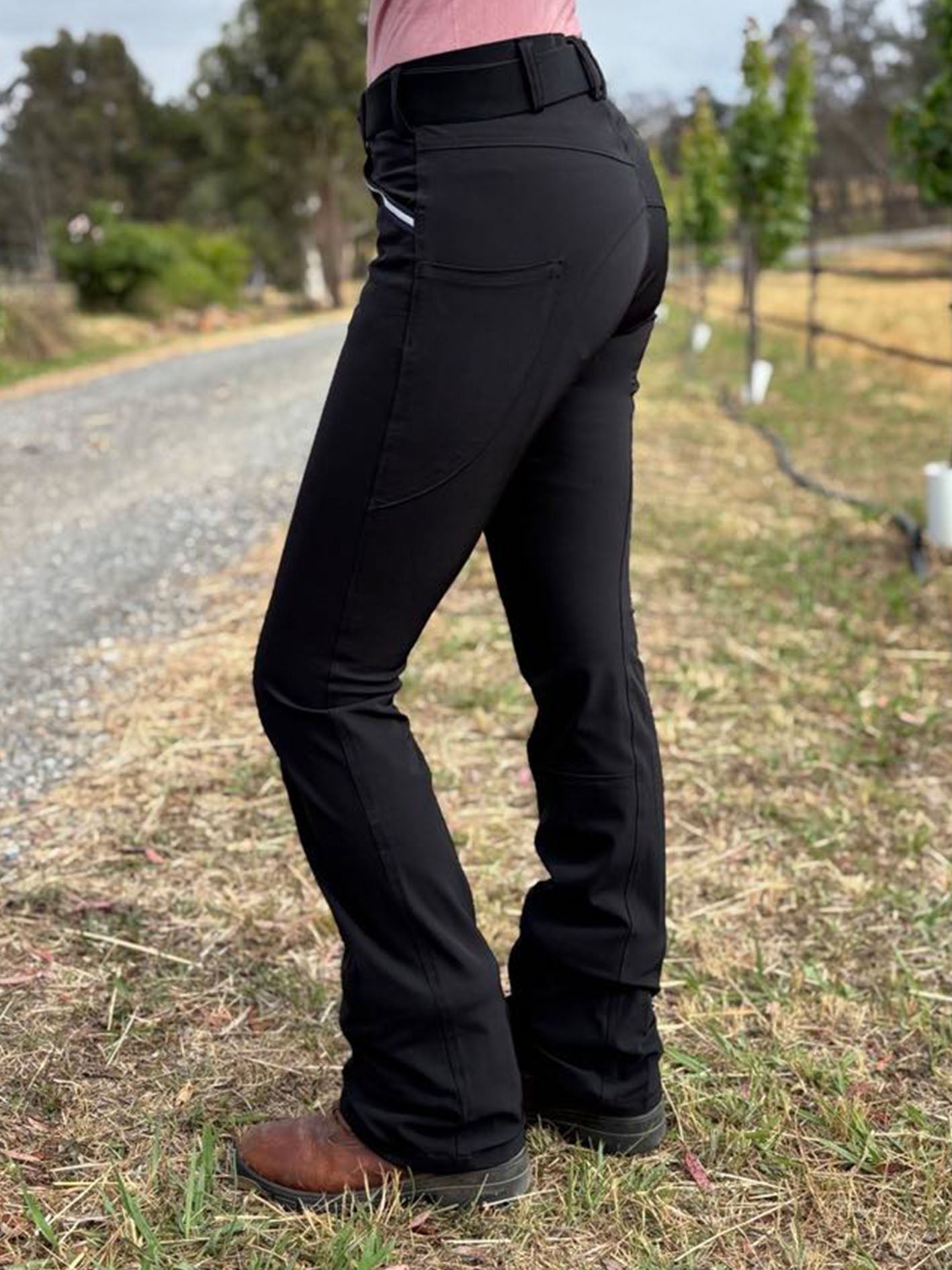 Shows a woman wearing the bootleg horse riding pants in black.