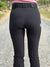 Close up of the back view of a woman wearing the bootleg riding pants. 