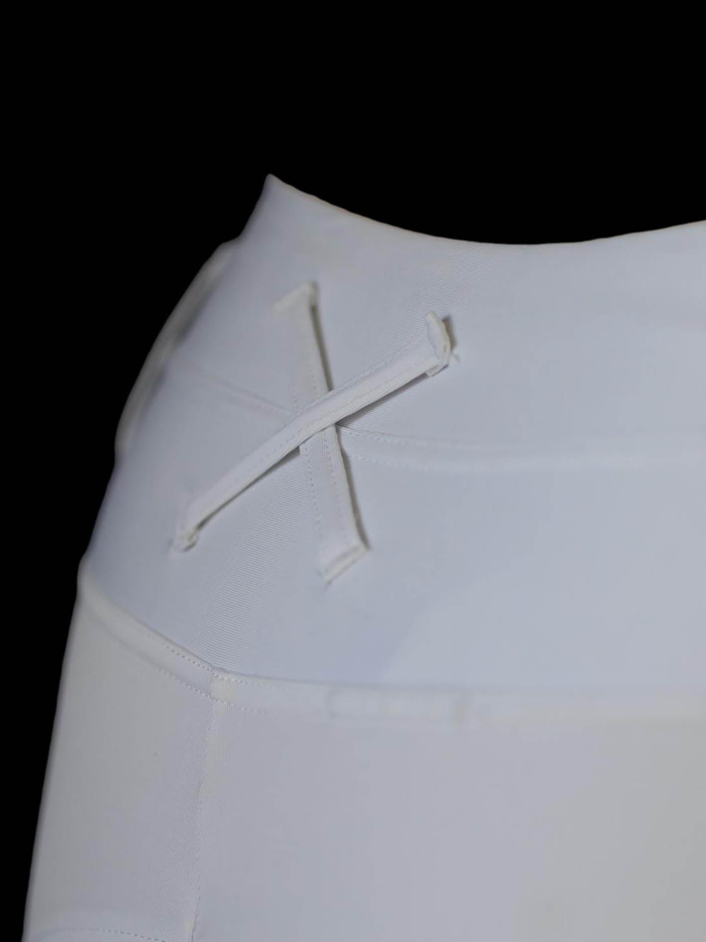 White dressage pants showing extreme close up of back of waistband and cross over belt loop detail 