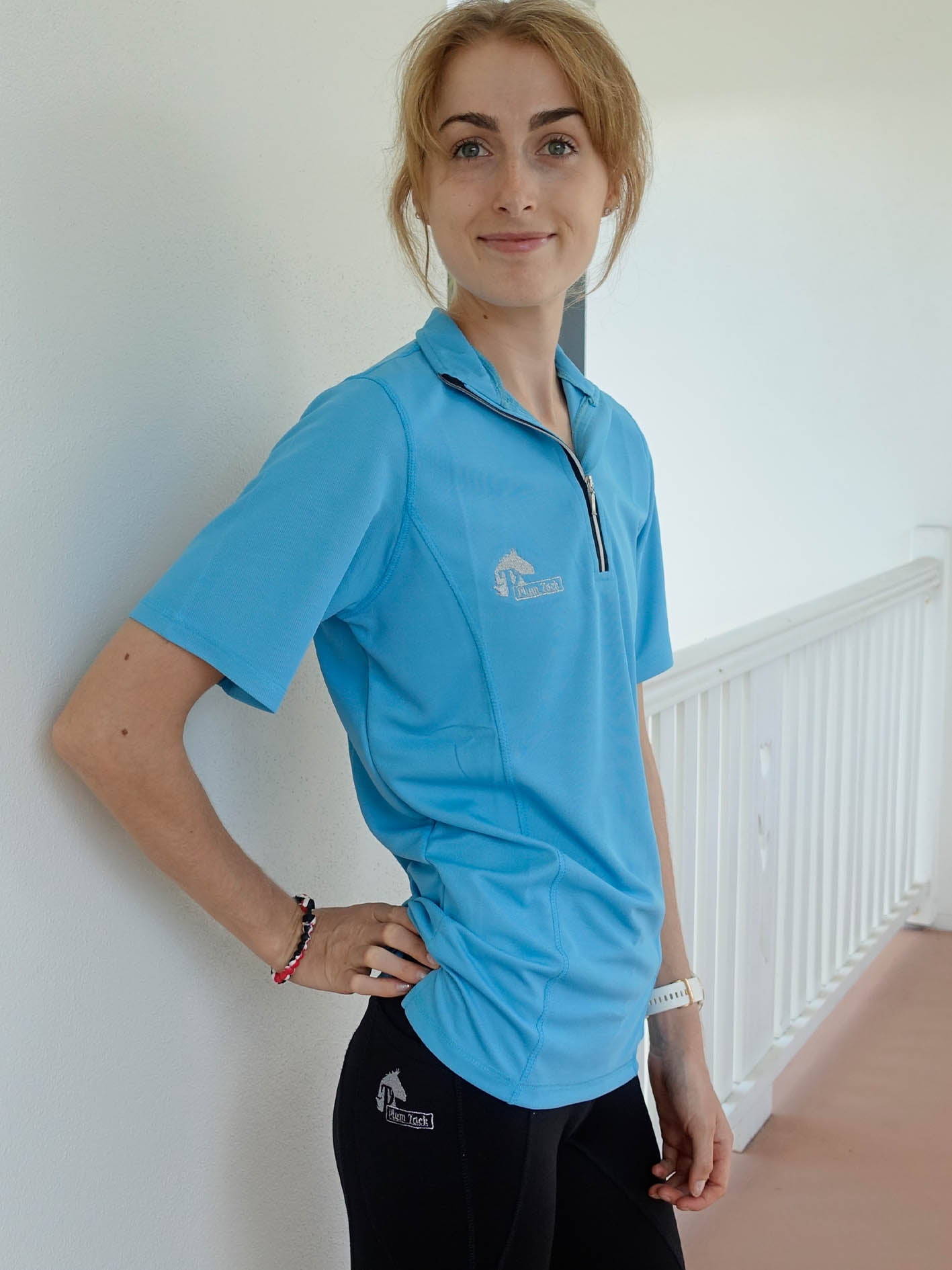 Casual pose of woman wearing sky blue riding top 